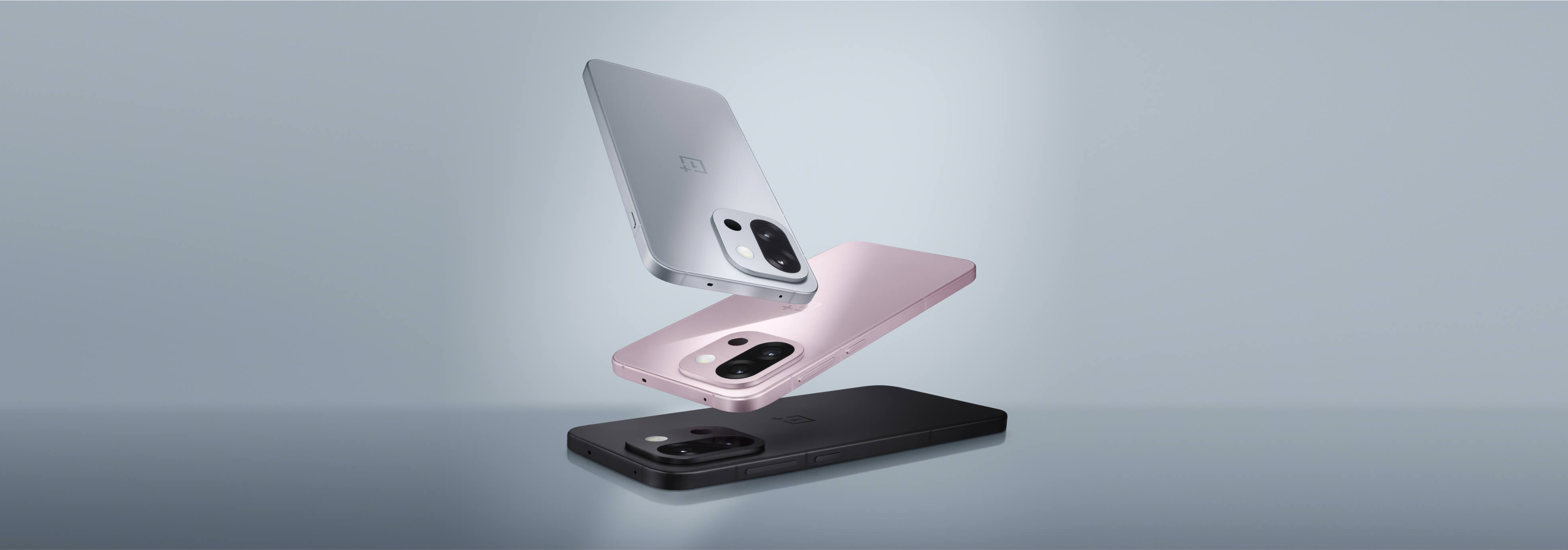 Three silver and pink smartphones with reflective surfaces.